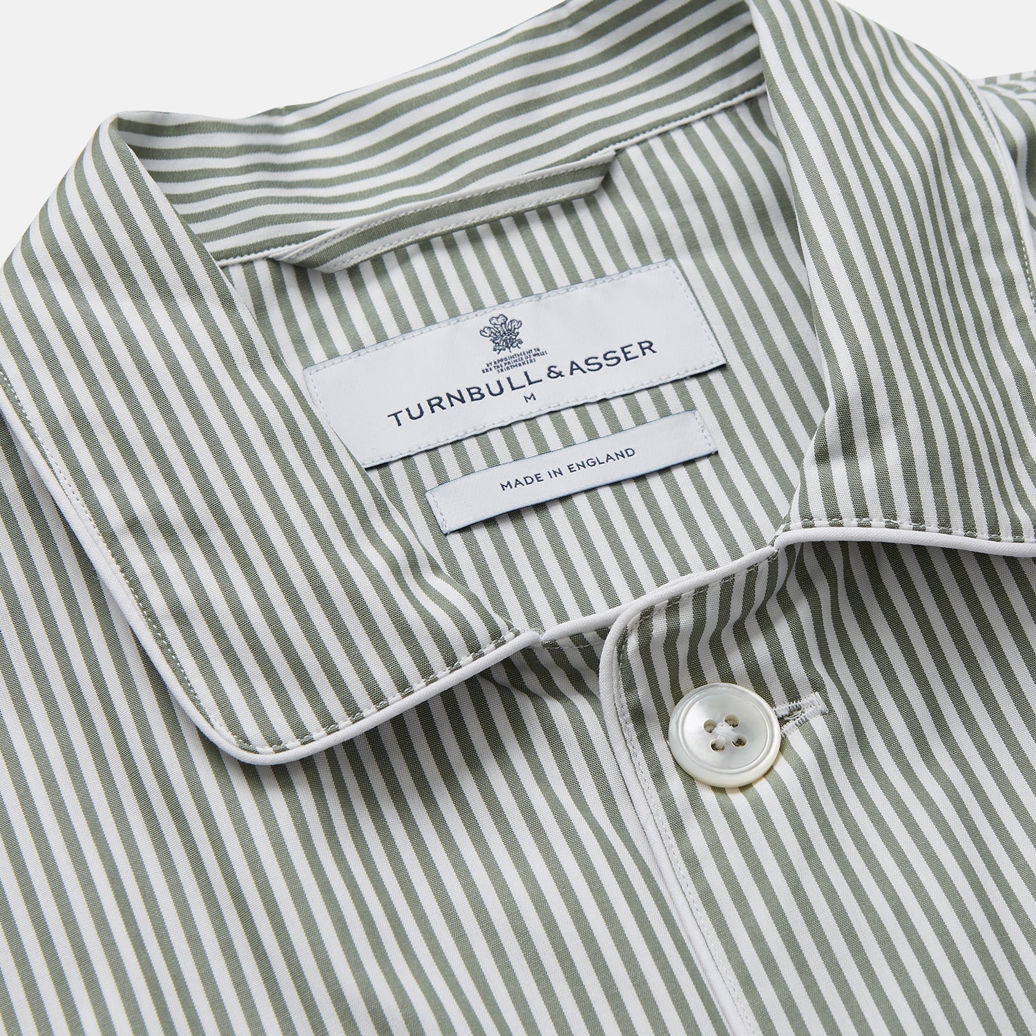 View 2 of product The Turnbull & Asser Green Bengal Stripe Modern Fit Cotton Pyjama Set features a long-sleeve button-up shirt with chest pocket and elastic waistband pants, crafted from soft Italian cotton and displayed on a white background.