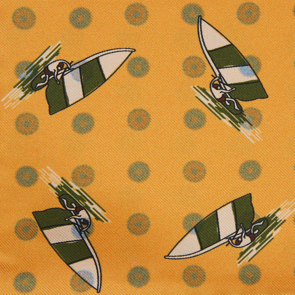 The Turnbull & Asser Yellow Windsurfer Double-Faced Silk Print Pocket Square features playful windsurfers on yellow silk, with a contrasting edge for a refined touch.