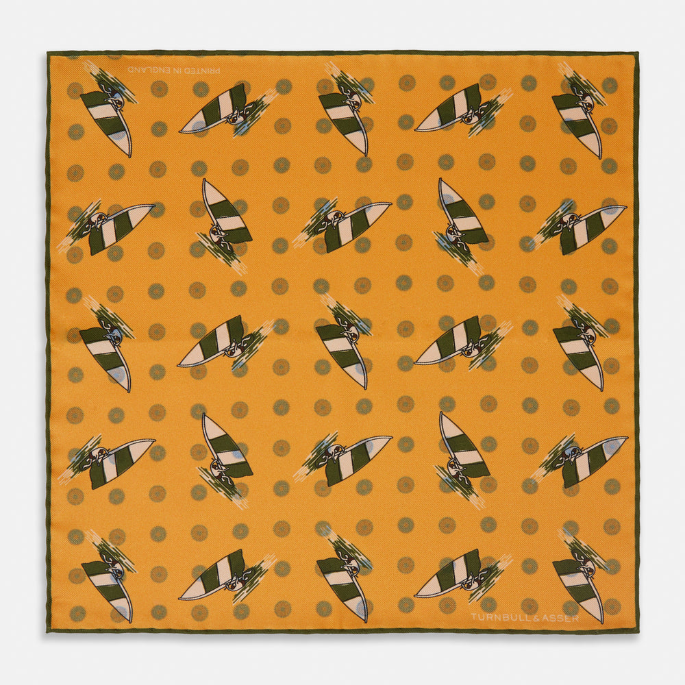 The Turnbull & Asser Yellow Windsurfer Double-Faced Silk Print Pocket Square features playful windsurfers on yellow silk, with a contrasting edge for a refined touch.