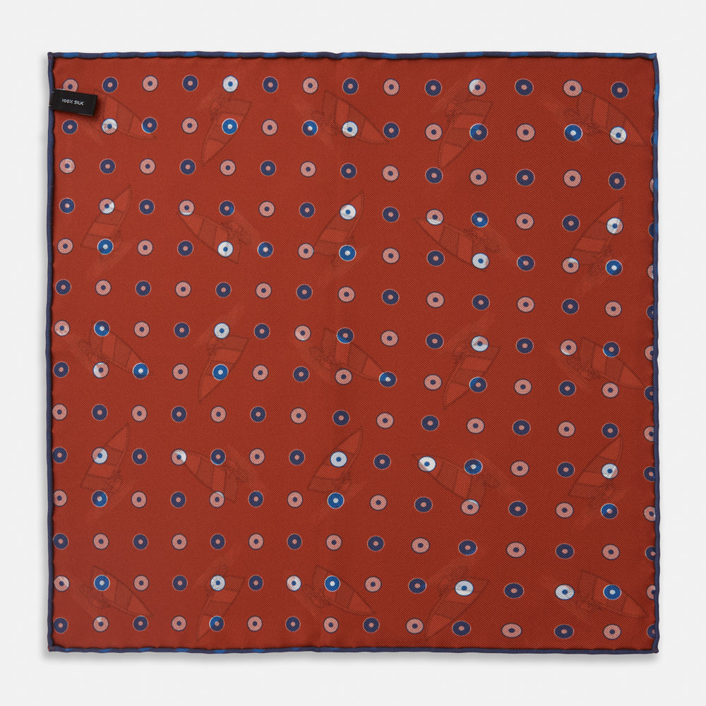 The Turnbull & Asser Red Windsurfer Double-Faced Silk Print Pocket Square features a vibrant windsurfer pattern on silk with a dark blue border and the brand subtly printed in one corner.
