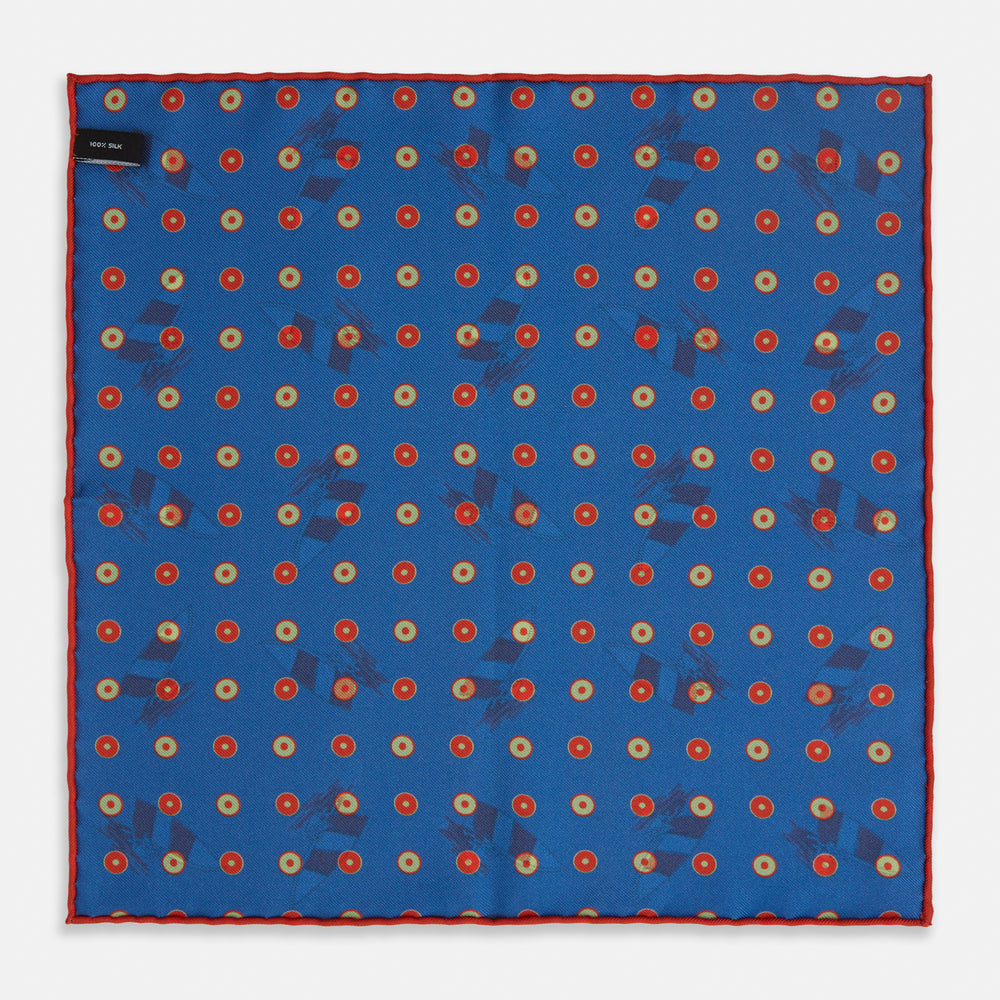 The Turnbull & Asser Blue Windsurfer Double-Faced Silk Print Pocket Square features a blue silk design with colorful windsurfers and vivid red edges, finished with the Turnbull & Asser logo in one corner.