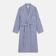The Turnbull & Asser Navy Check Cotton Gown features long sleeves, white piping, a shawl collar, chest pocket, and matching waist belt, all in a blue plaid pattern. Shown against a plain white background.