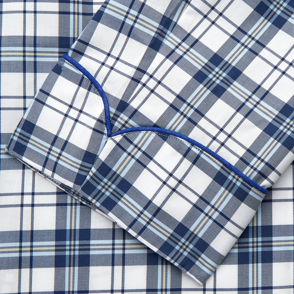 The Turnbull & Asser Blue Check Cotton Gown features long sleeves, a knee-length cut, shawl collar, and matching waist belt in a blue check pattern, shown against a plain white background.