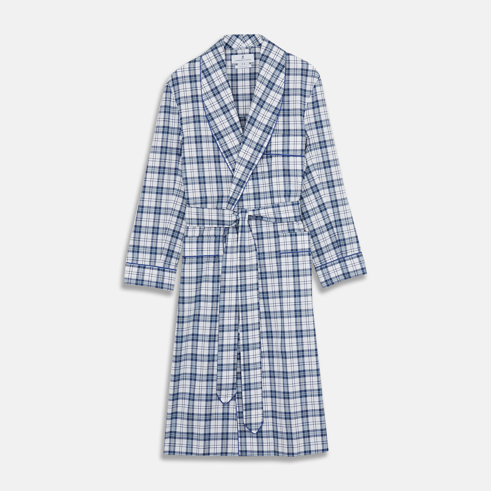 The Turnbull & Asser Blue Check Cotton Gown features long sleeves, a knee-length cut, shawl collar, and matching waist belt in a blue check pattern, shown against a plain white background.