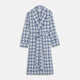 The Turnbull & Asser Blue Check Cotton Gown features long sleeves, a knee-length cut, shawl collar, and matching waist belt in a blue check pattern, shown against a plain white background.