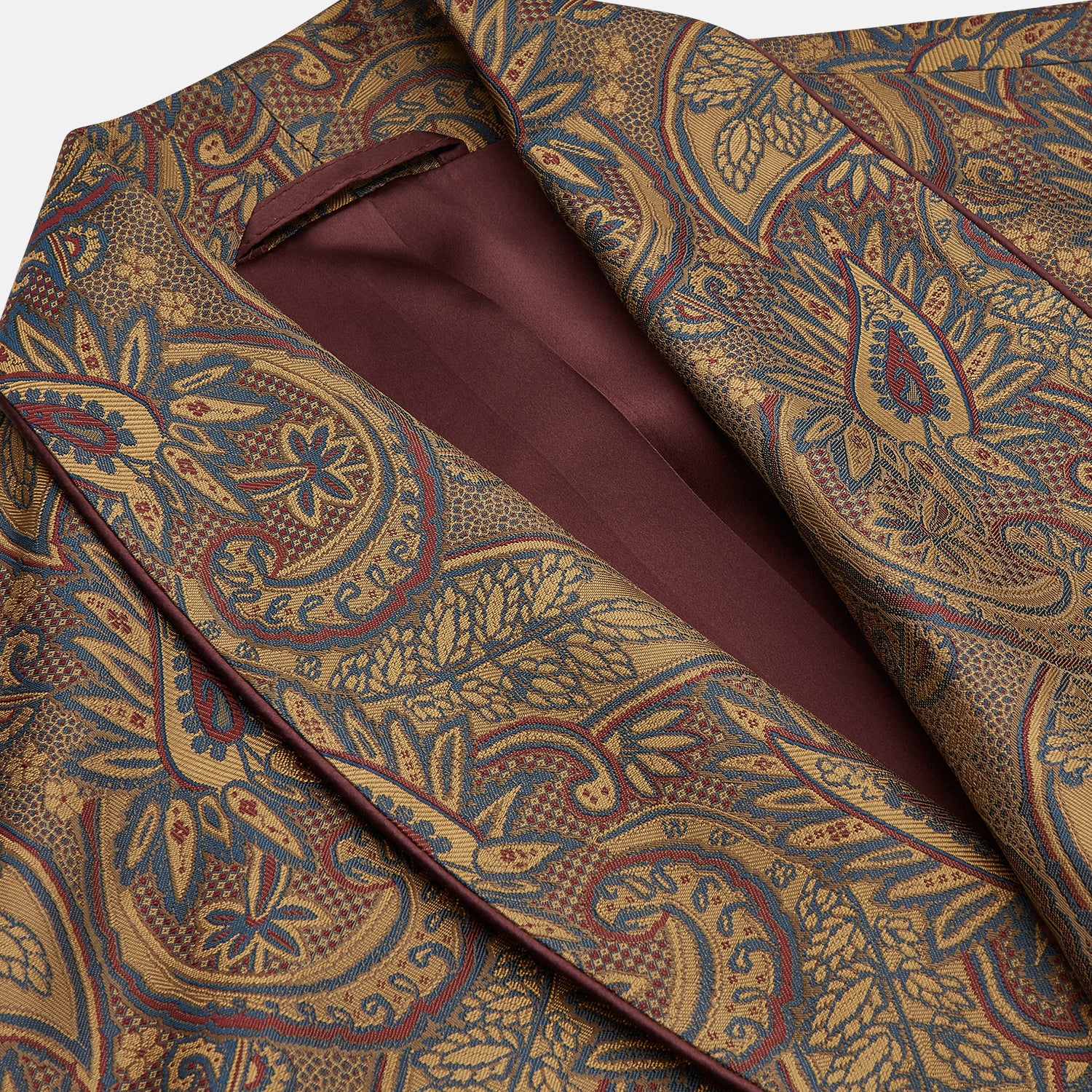 View 2 of product The Turnbull & Asser Gold Paisley Traditional Silk Jacquard Gown features a brown and gold paisley pattern, shawl collar, front pockets, and matching fabric belt. Displayed on a white background, it’s perfect for winter comfort.