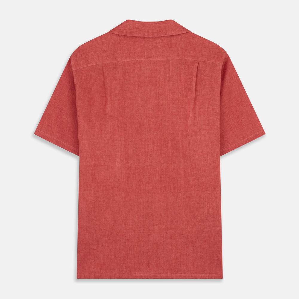 The Turnbull & Asser Crimson Delave Linen Holiday Fit Shirt features a solid brick-red hue, short sleeves, single chest pocket, and revere collar—perfect resort wear—shown laid flat on white.