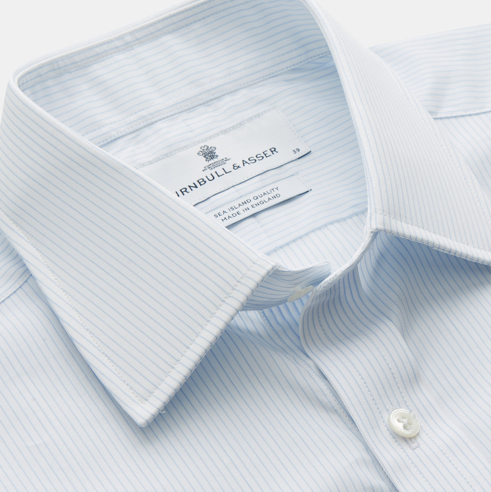 The Turnbull & Asser Pale Blue Stripe Regular Fit Sea Island Quality Cotton Shirt features a T&A collar and 3-button cuffs, laid flat on a white background.