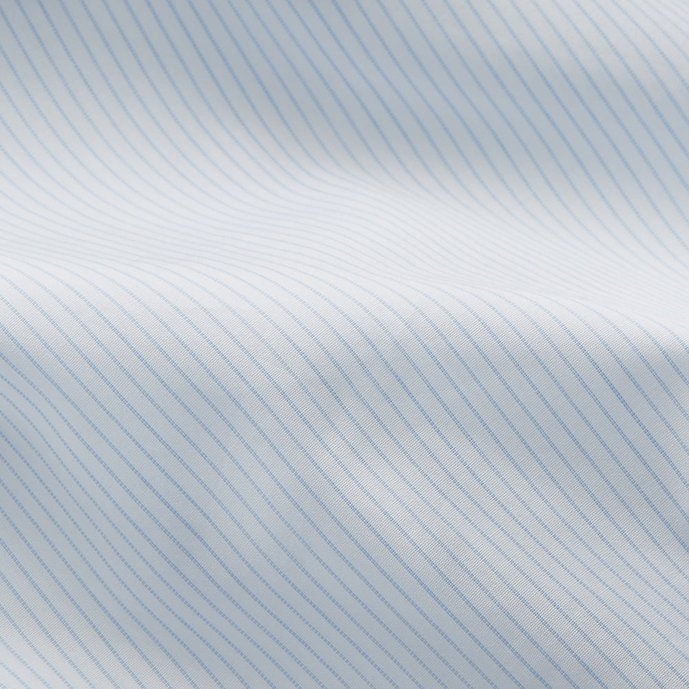 The Turnbull & Asser Pale Blue Stripe Regular Fit Sea Island Quality Cotton Shirt features a T&A collar and 3-button cuffs, laid flat on a white background.