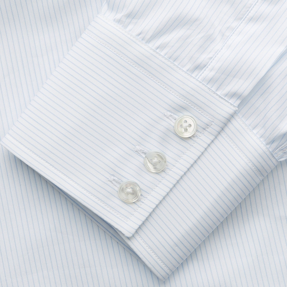 The Turnbull & Asser Pale Blue Stripe Regular Fit Sea Island Quality Cotton Shirt features a T&A collar and 3-button cuffs, laid flat on a white background.