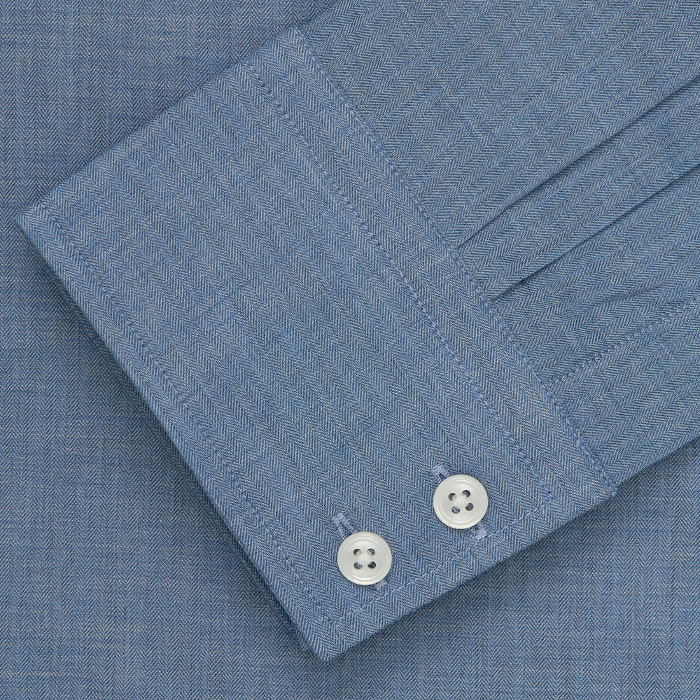 The Turnbull & Asser Blue Tailored Fit Shirt features a Kent collar, 2-button cuffs, and white buttons—a versatile men’s wardrobe essential. Laid flat on a white background.