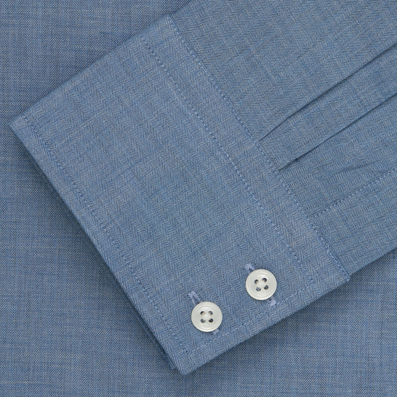 View 3 of product The Turnbull & Asser Blue Tailored Fit Shirt features a Kent collar, 2-button cuffs, and white buttons—a versatile men’s wardrobe essential. Laid flat on a white background.