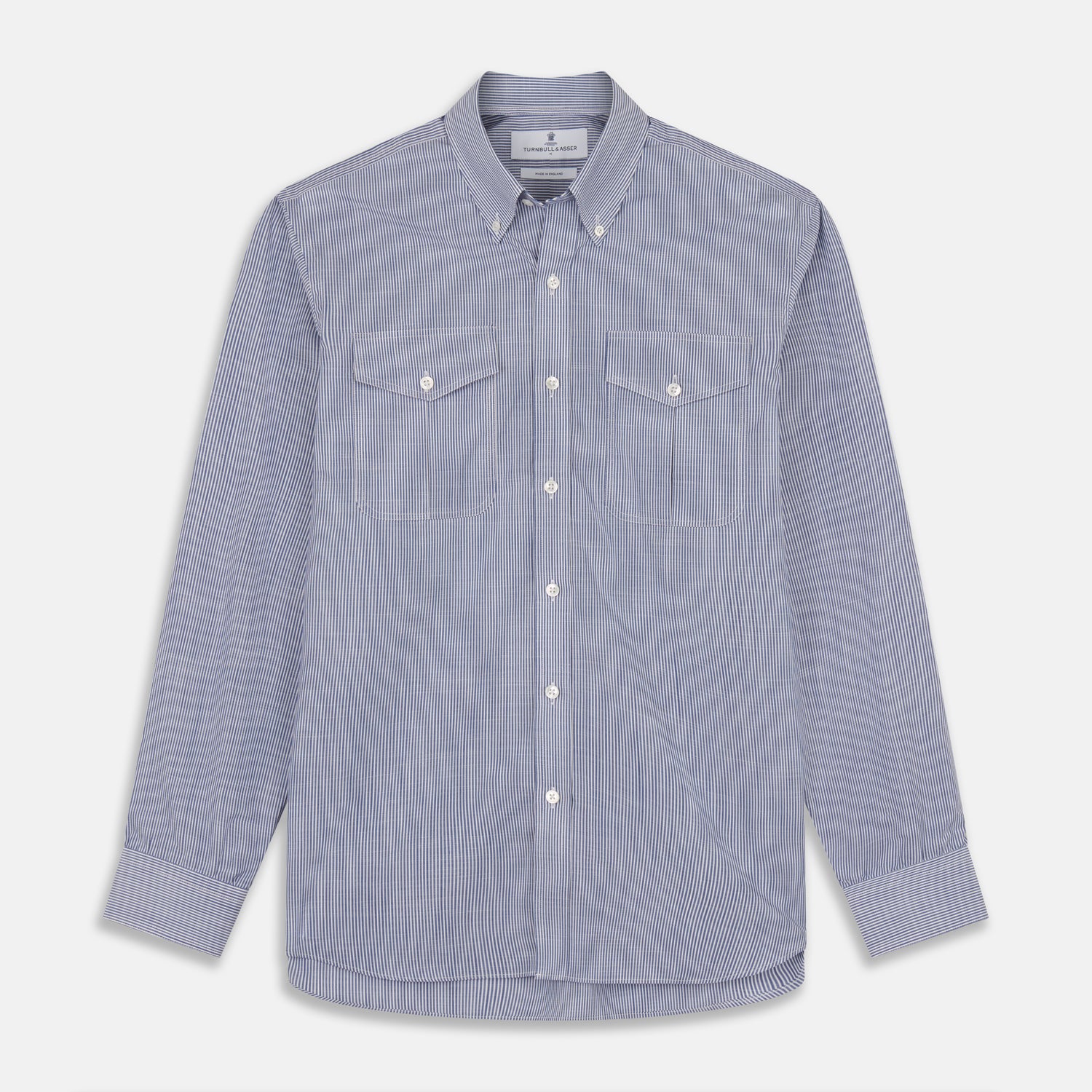 View 1 of product Turnbull & Asser’s Indigo Chambray Stripe Weekend Fit Shirt with Dorset collar features thin white pinstripes, two button-flap chest pockets, buttoned cuffs, and relaxed styling—presented flat on a white background.