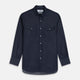 The Turnbull & Asser Navy Chambray Weekend Fit Shirt features a Dorset collar, long sleeves with 1-button cuffs, and two button-flap chest pockets. This officer’s shirt is displayed flat on a white background.