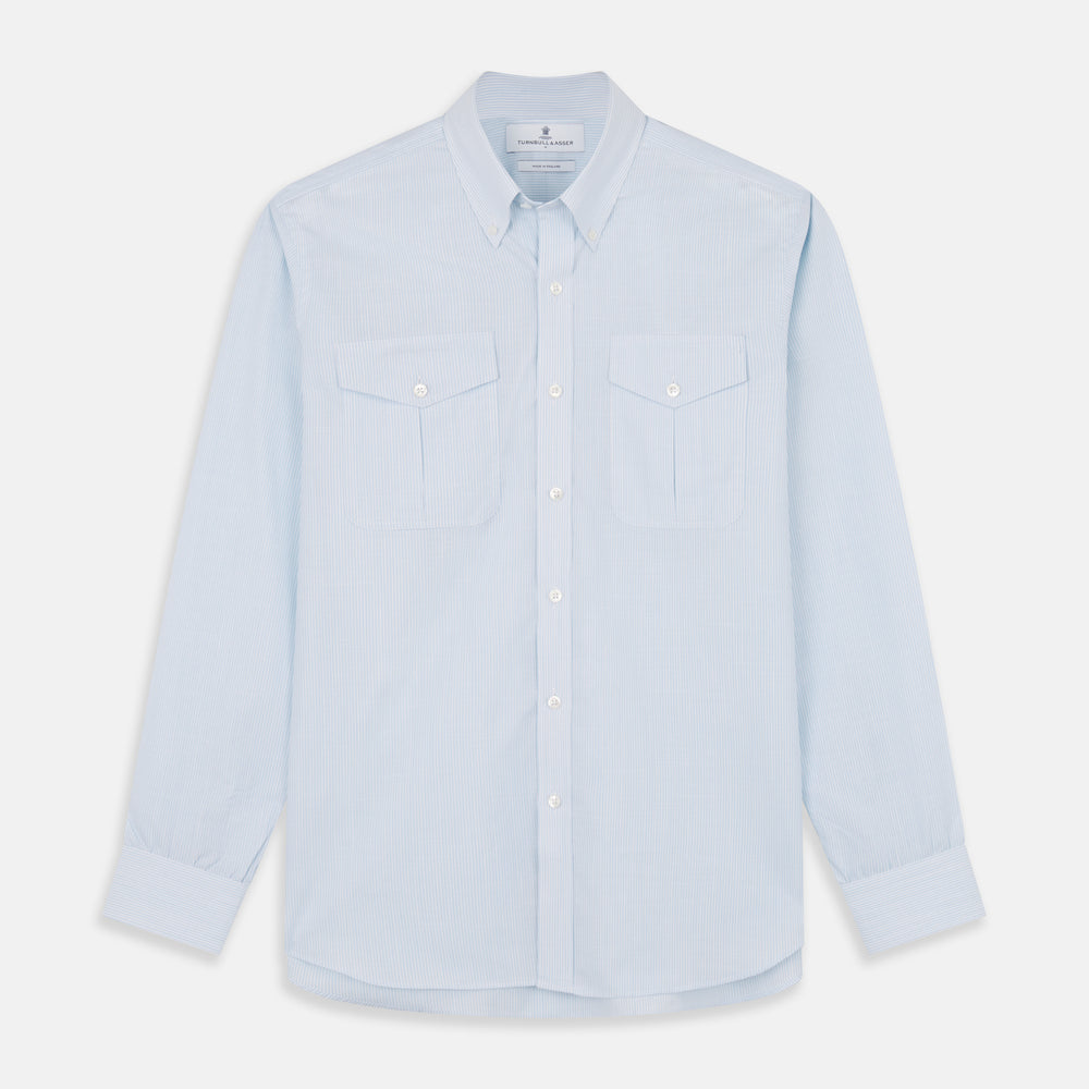 The Turnbull & Asser Sky Blue Chambray Stripe Weekend Fit Shirt features a Dorset collar, long sleeves, and two button-flap chest pockets, offering a relaxed look. Displayed on a plain white background.