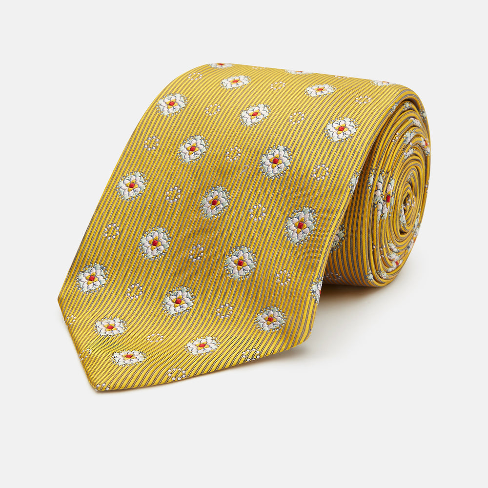 The Yellow Multi Floral Motif Silk Tie by Turnbull & Asser features subtle diagonal stripes and small white, blue, and orange floral motifs—a perfect summer palette, shown rolled up on a plain white background.