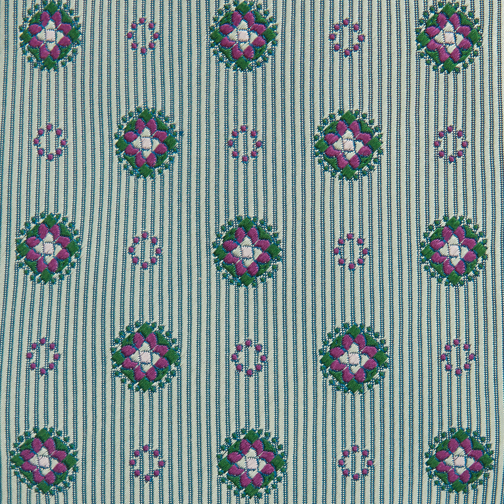 The Green Multi Floral Motif Silk Tie by Turnbull & Asser features light gray silk with thin diagonal stripes and a floral medallion pattern in pink, purple, and green—ideal for adding summer color to your outfit. Displayed rolled up on a white background.