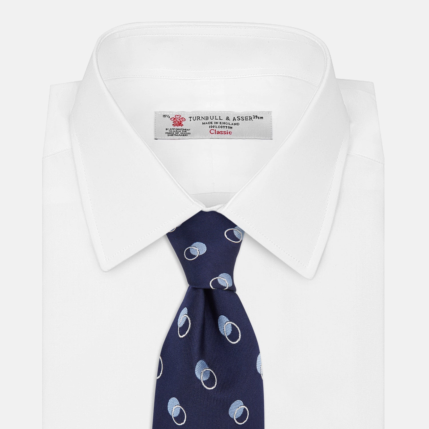 View 2 of product The Turnbull & Asser Navy Multi Circle Silk Tie showcases overlapping light blue and white rings on navy silk—a stylish choice to elevate bold shirts or bring visual interest to your summer look.