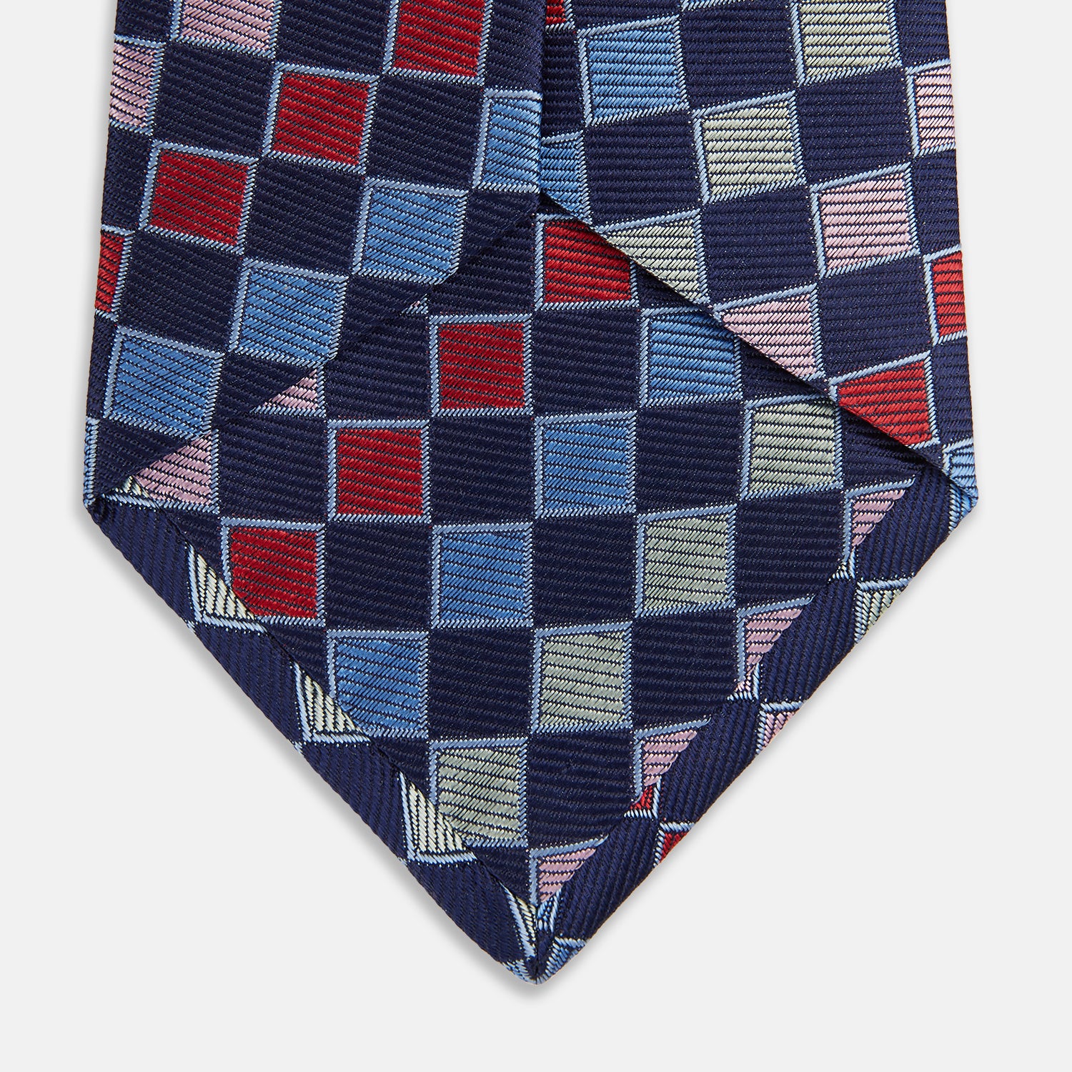 View 4 of product The Pink Multi Check Silk Tie by Turnbull & Asser features blue, red, and light green squares on a white background—an ideal summer accessory that complements bold shirts.