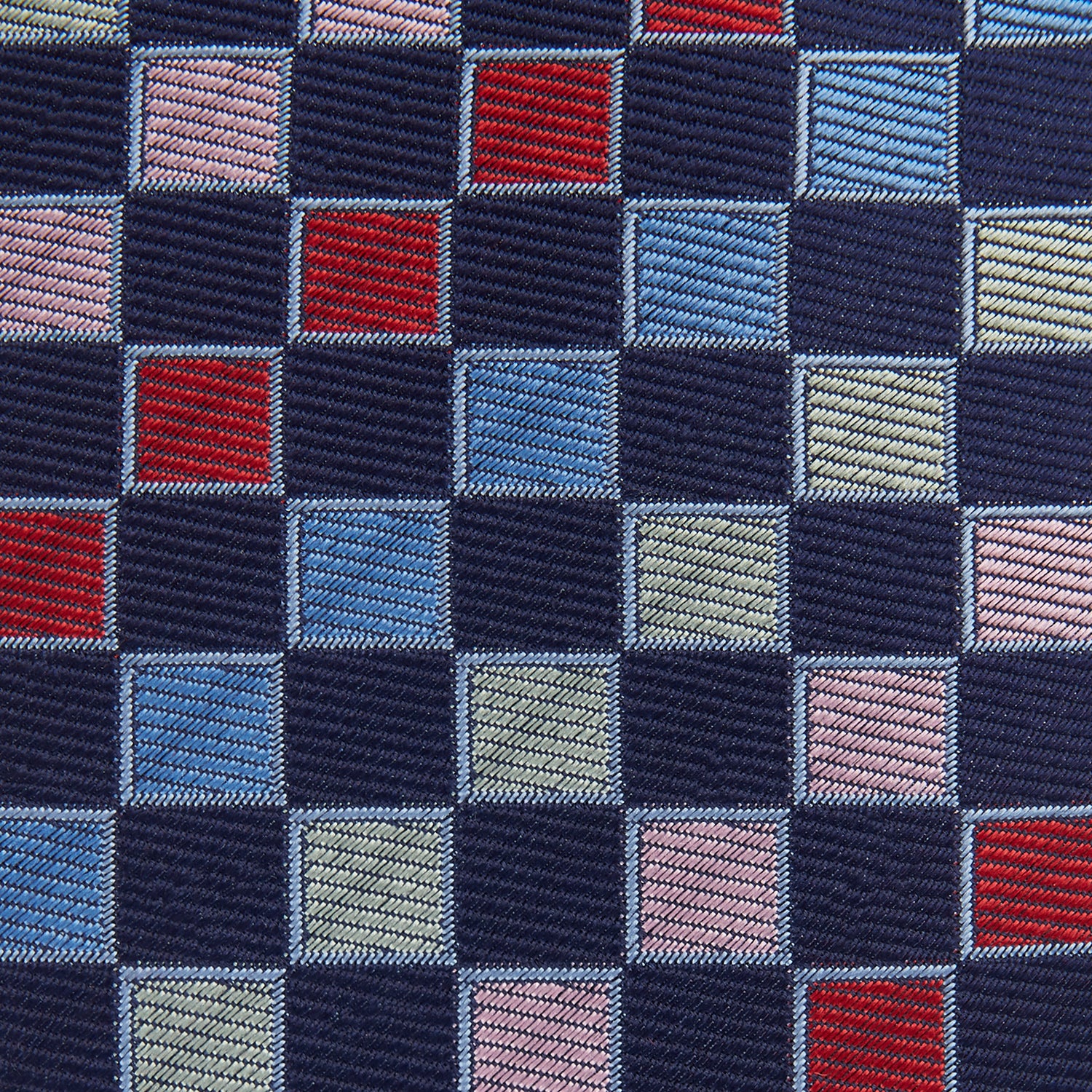 View 3 of product The Pink Multi Check Silk Tie by Turnbull & Asser features blue, red, and light green squares on a white background—an ideal summer accessory that complements bold shirts.