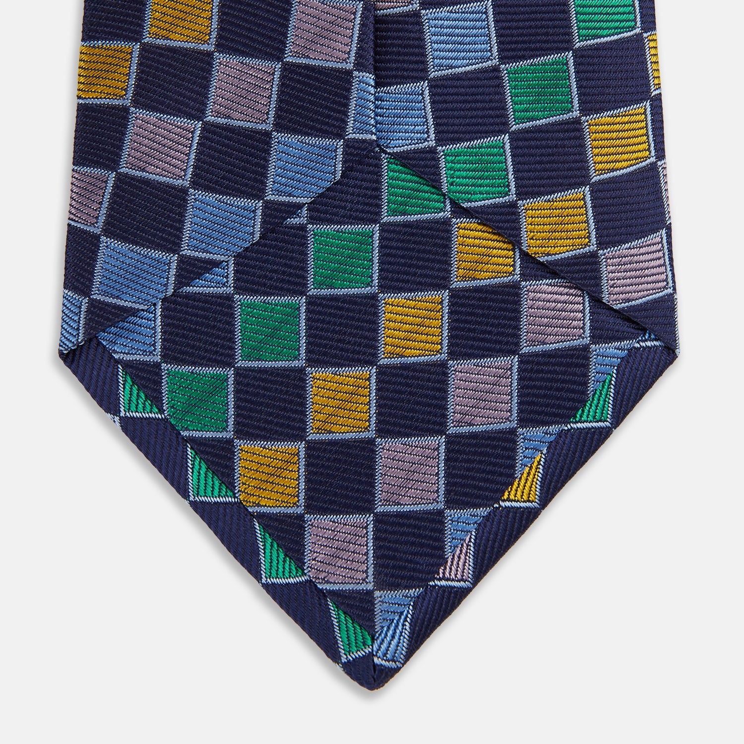 View 4 of product The Green Multi Check Silk Tie by Turnbull & Asser features a green checkered pattern with blue, yellow, and light purple squares on dark blue—ideal for bold shirts and a vibrant summer palette.