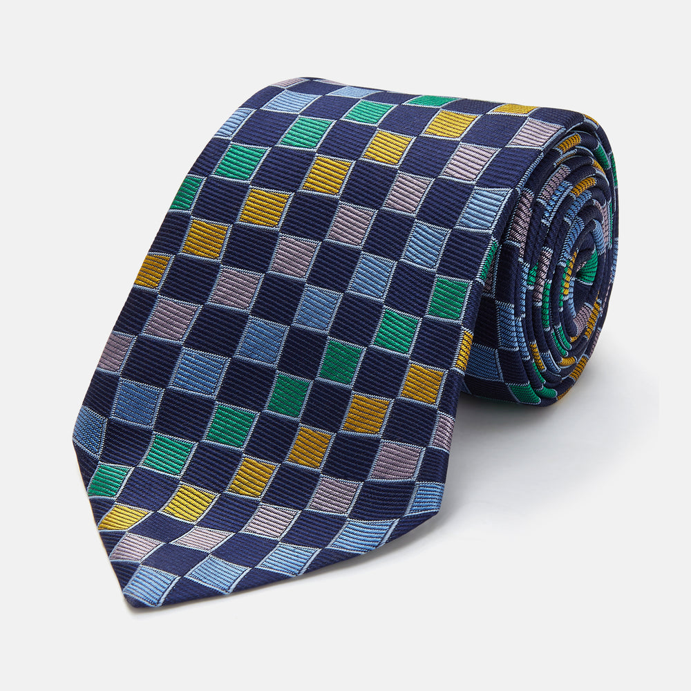 The Green Multi Check Silk Tie by Turnbull & Asser features a green checkered pattern with blue, yellow, and light purple squares on dark blue—ideal for bold shirts and a vibrant summer palette.