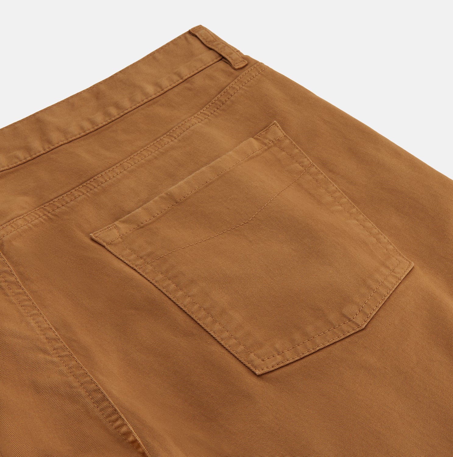 View 2 of product Tan Stretch Cotton Five-Pocket Mylo Jeans by Turnbull & Asser, featuring a classic straight-leg cut, are displayed flat on a white background—showcasing timeless style and quality craftsmanship.