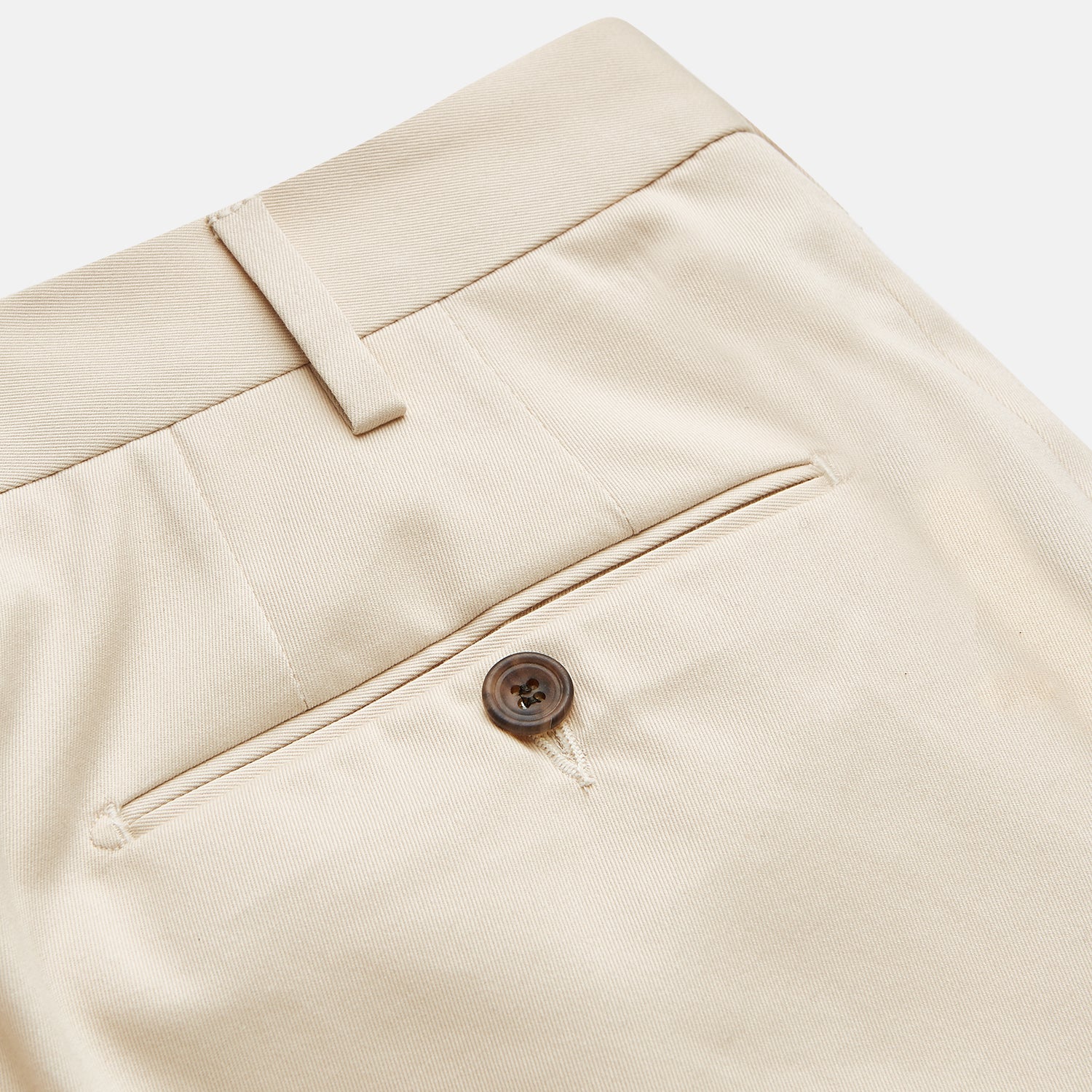 View 2 of product The Turnbull & Asser Sand Cotton Pleated Gerry Trouser features belt loops, front pockets, a button closure, and a classic fit. Shown laid flat on a white background.
