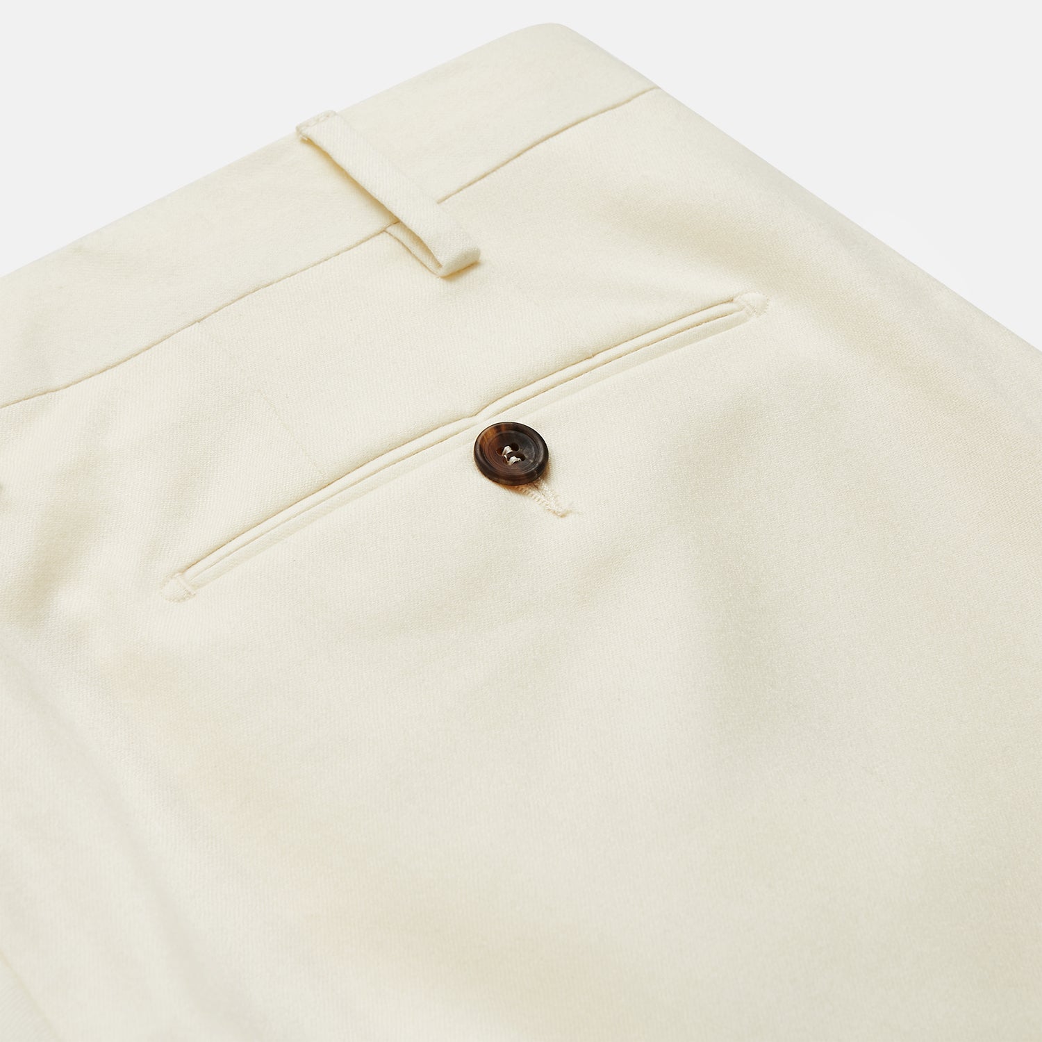 View 4 of product The Cream Lightweight Wool Pleated Jasper Trouser by Turnbull & Asser features side pockets and a button closure, expertly crafted from lightweight wool in cream and displayed on a plain white background.
