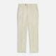 The Cream Lightweight Wool Pleated Jasper Trouser by Turnbull & Asser features side pockets and a button closure, expertly crafted from lightweight wool in cream and displayed on a plain white background.