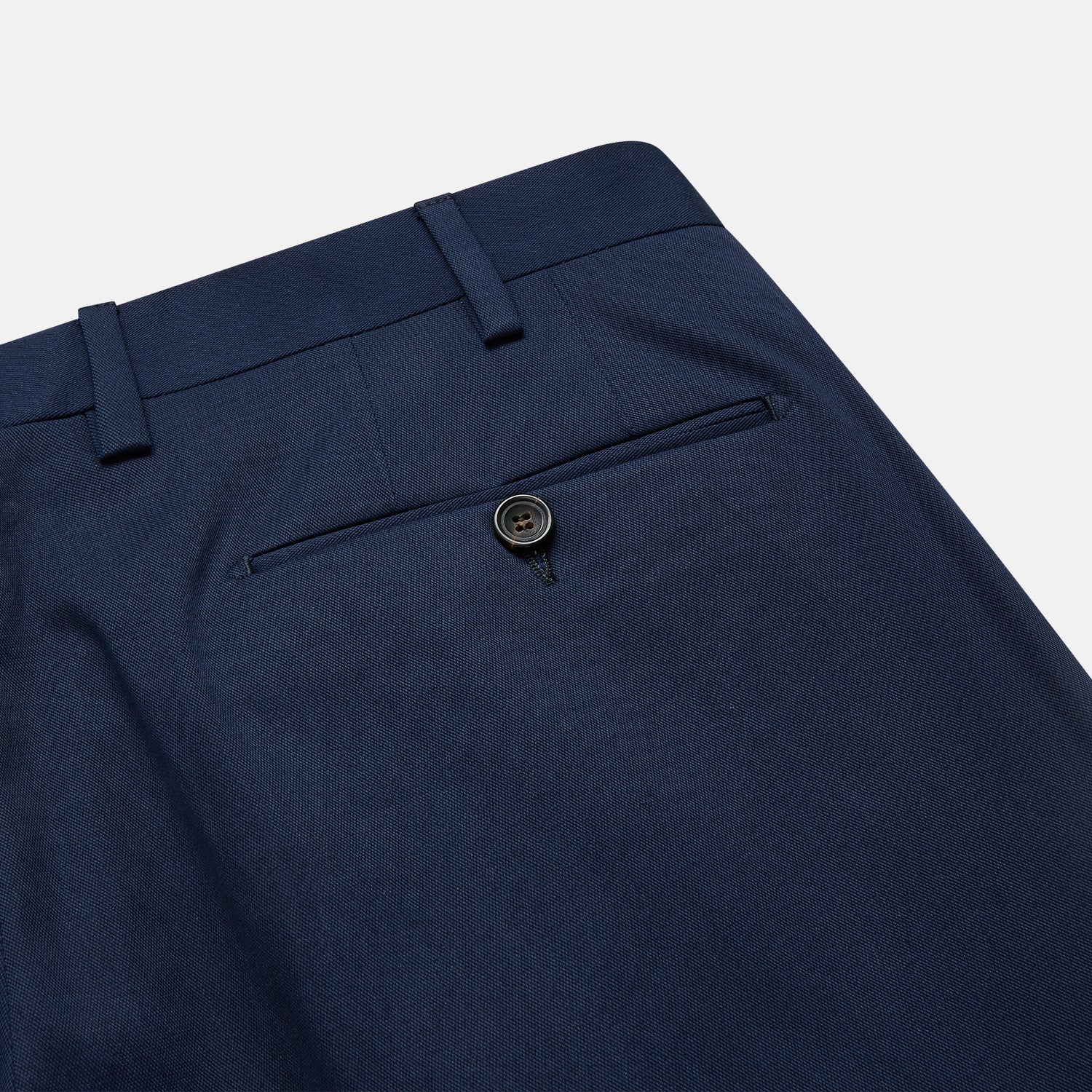 View 2 of product The Turnbull & Asser Navy Front Pleated Gerry Trouser is shown laid flat, featuring a classic straight leg, button and zip closure, belt loops, and crisp front pleats.