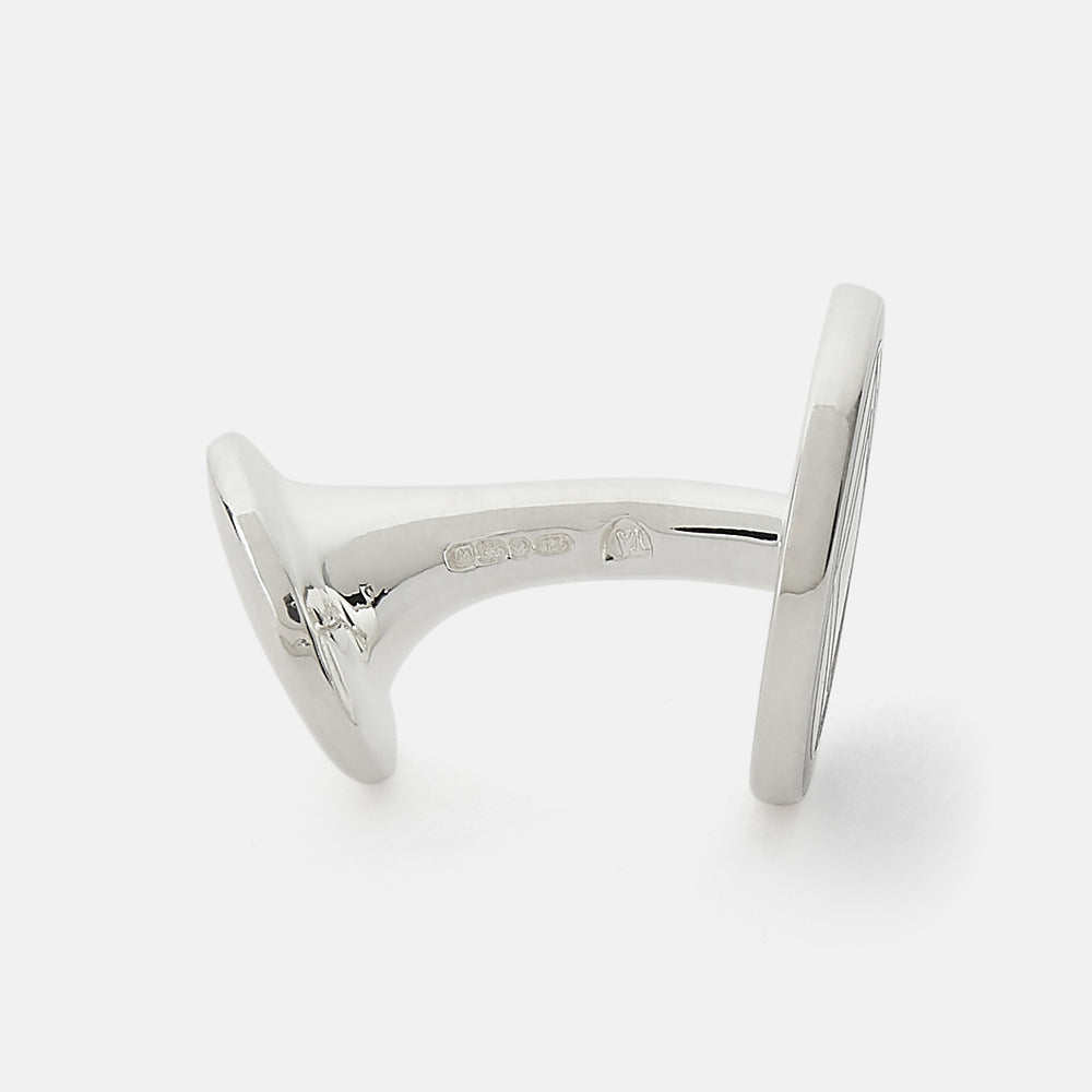 Turnbull & Asser's Pale Pink Sterling Silver Cufflinks feature a round design with a geometric square pattern on a pale pink background—an elegant accessory for men, displayed on a white surface.
