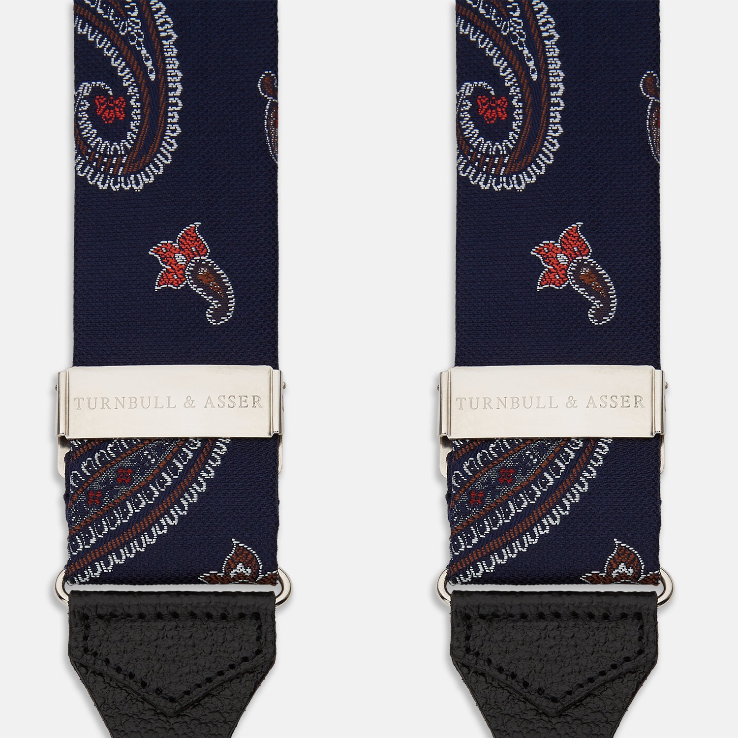View 2 of product A pair of Navy Paisley Adjustable Silk Braces by Turnbull & Asser, featuring black leather loops and silver-tone adjusters, is displayed on a white background.