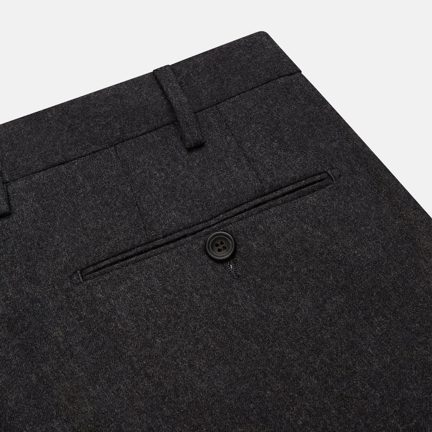 View 2 of product Turnbull & Asser Charcoal Grey Wool Manson Trousers, tailored in Italy with a straight-leg cut, front creases, belt loops, and button closure, are displayed flat on a white background.