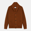 View 1 of product The Brown Ainsley Ribbed Shawl Cashmere Cardigan by Turnbull & Asser features a ribbed knit texture, black front buttons, and two front pockets, displayed laid flat on a white background.