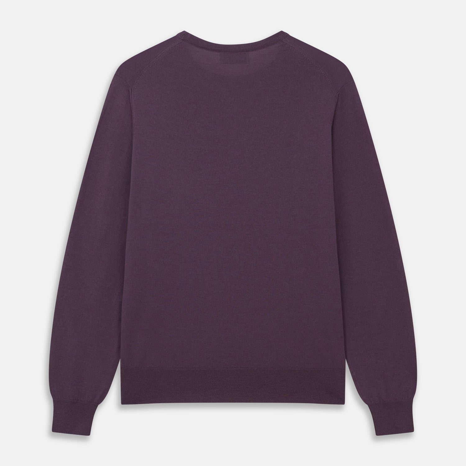 View 3 of product The Turnbull & Asser Plum Kingston Merino Crew Neck Jumper is a lightweight, long-sleeve sweater with ribbed cuffs and hem, shown flat on a white background. Its solid plum color and classic design offer timeless style.