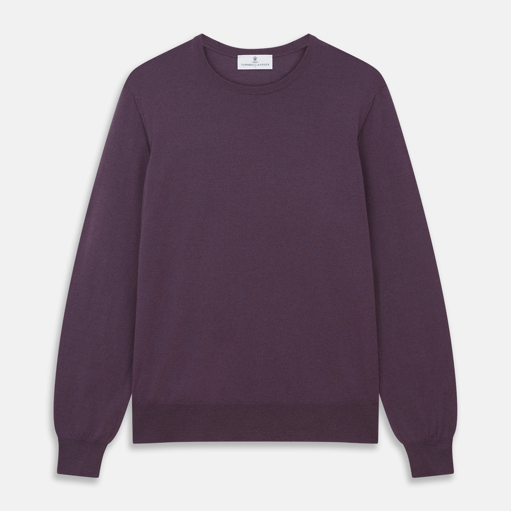 The Turnbull & Asser Plum Kingston Merino Crew Neck Jumper is a lightweight, long-sleeve sweater with ribbed cuffs and hem, shown flat on a white background. Its solid plum color and classic design offer timeless style.