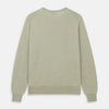 View 3 of product The Light Green Kingston Merino Crew Neck Jumper by Turnbull & Asser is laid flat, displaying its classic design with ribbed cuffs, hem, and neckline.