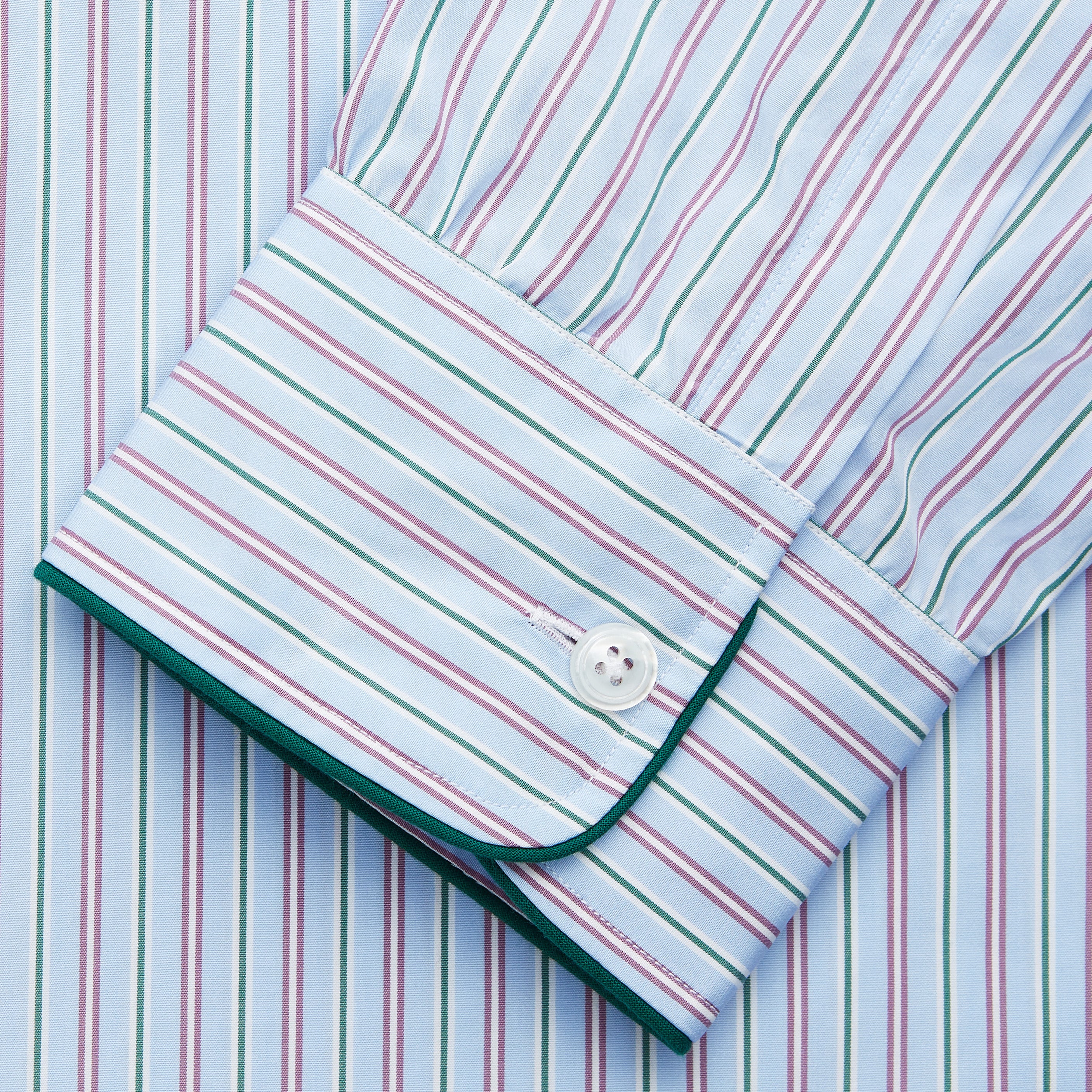 View 3 of product The Blue, Purple & Green Stripe Nightshirt by Turnbull & Asser is a long-sleeved, knee-length traditional nightshirt with a pointed collar, breast pocket with green trim, front buttons, and buttoned cuffs; made in England.