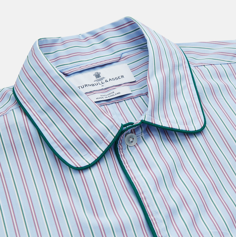 The Blue, Purple & Green Stripe Nightshirt by Turnbull & Asser is a long-sleeved, knee-length traditional nightshirt with a pointed collar, breast pocket with green trim, front buttons, and buttoned cuffs; made in England.