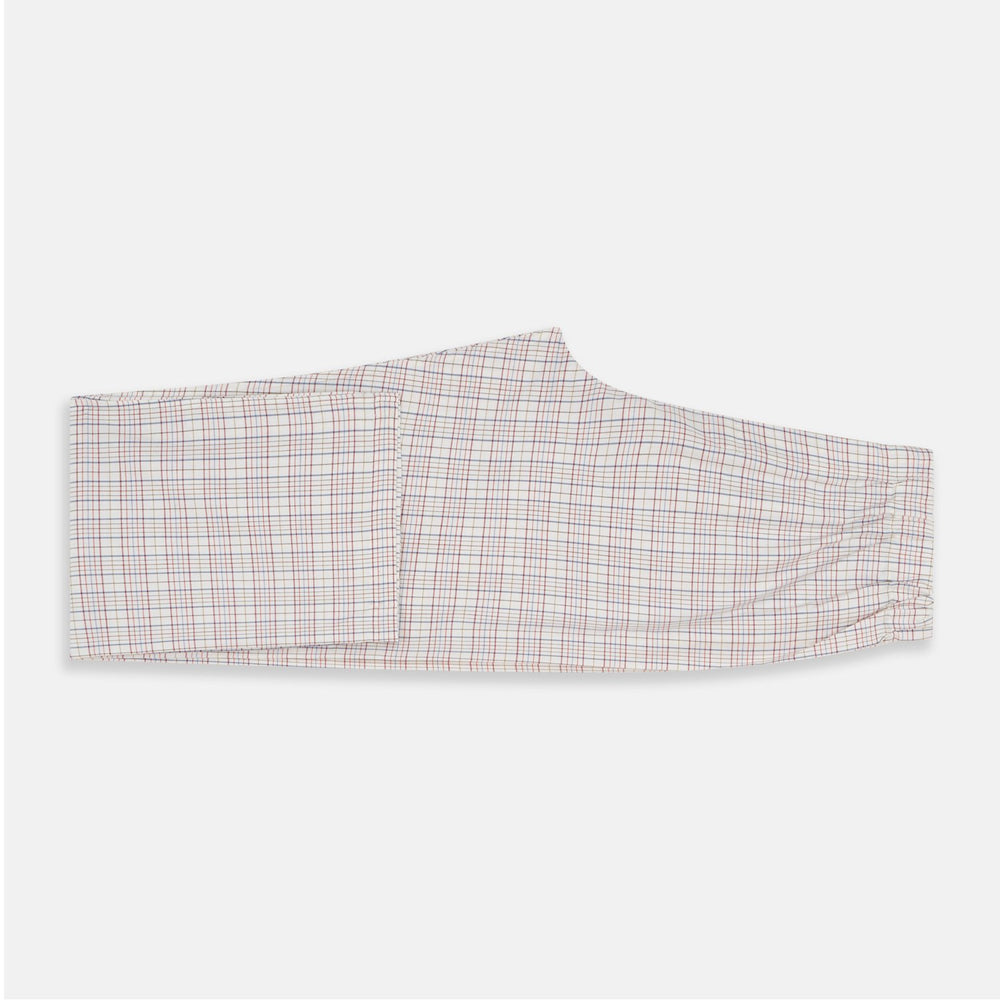 The Turnbull & Asser Red Multi Check Cotton-Cashmere Modern Pyjama Set, made in England, features a long-sleeve button-up shirt and pants in red and gray plaid with dark piping, crafted from soft Italian cotton-cashmere.