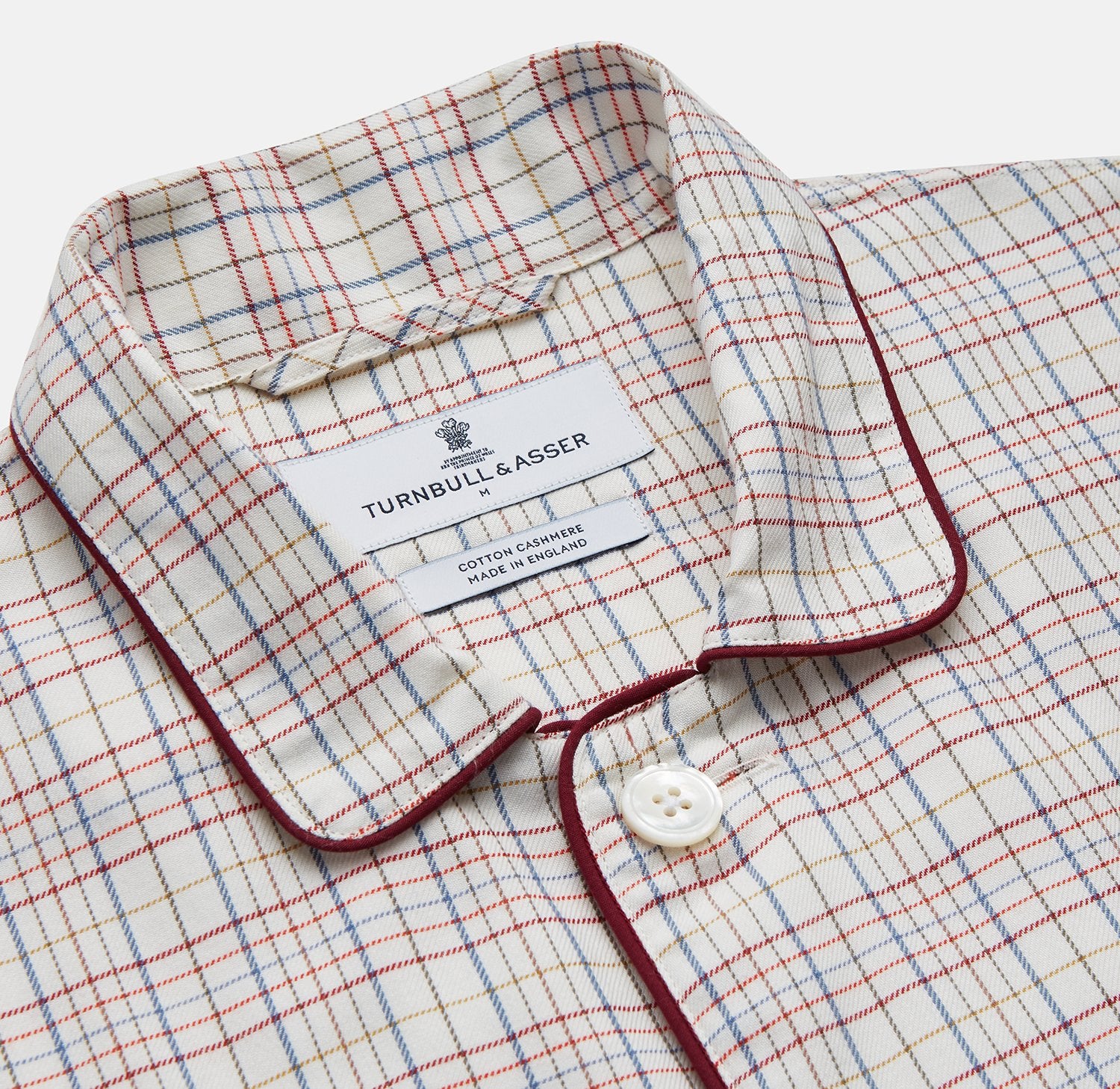 View 2 of product The Turnbull & Asser Red Multi Check Cotton-Cashmere Modern Pyjama Set, made in England, features a long-sleeve button-up shirt and pants in red and gray plaid with dark piping, crafted from soft Italian cotton-cashmere.