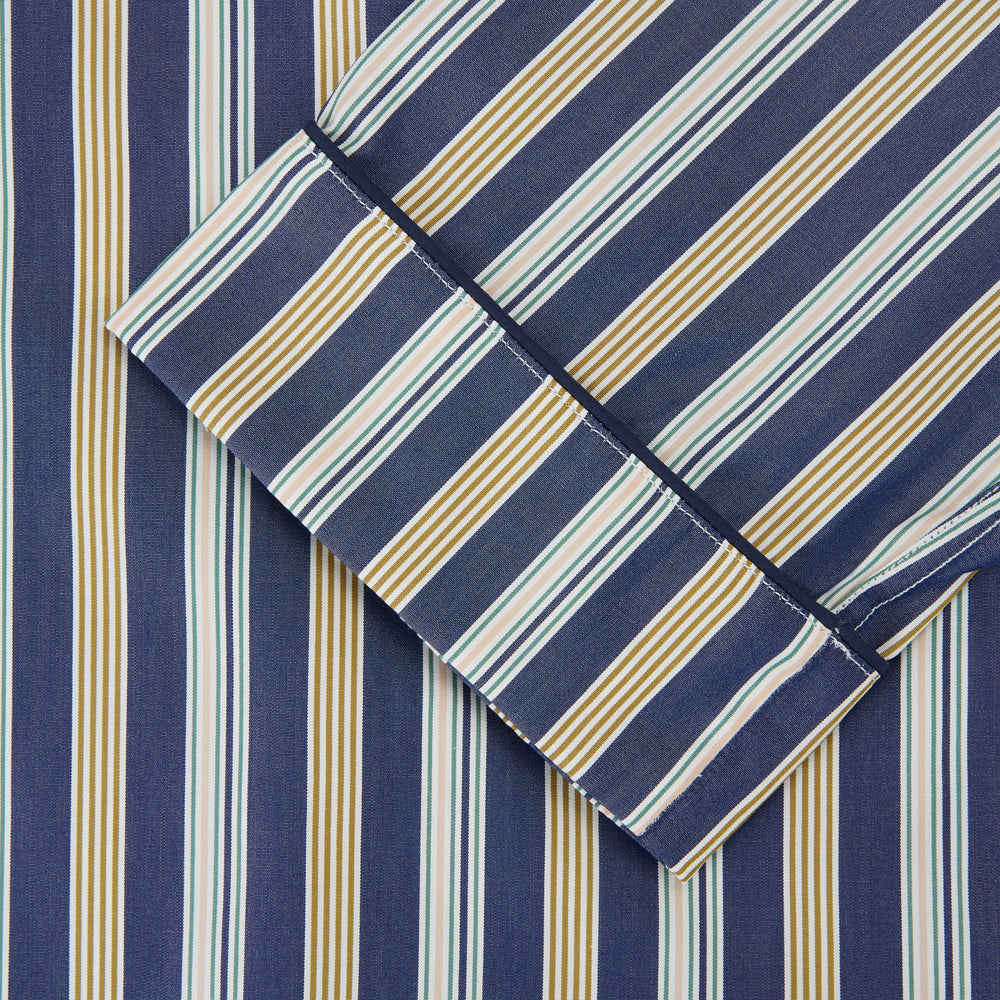 Turnbull & Asser's Blue Multi Stripe Cotton Modern Pyjama Set features a camp collar shirt with white buttons, front pocket, and long sleeves. Both pieces showcase classic blue and beige stripes for a timeless look.