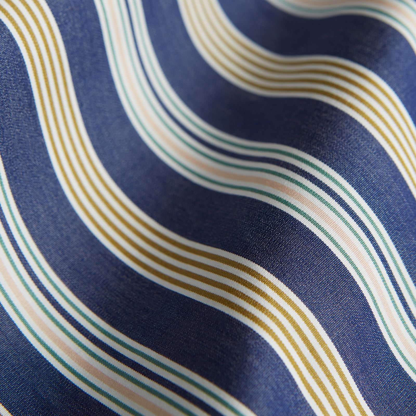 View 4 of product Turnbull & Asser's Blue Multi Stripe Cotton Modern Pyjama Set features a camp collar shirt with white buttons, front pocket, and long sleeves. Both pieces showcase classic blue and beige stripes for a timeless look.