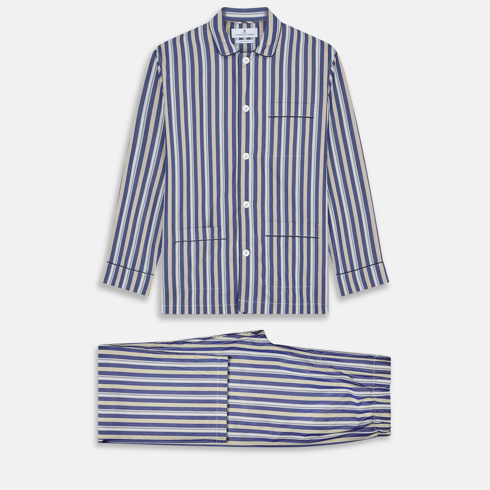 Turnbull & Asser's Blue Multi Stripe Cotton Modern Pyjama Set features a camp collar shirt with white buttons, front pocket, and long sleeves. Both pieces showcase classic blue and beige stripes for a timeless look.