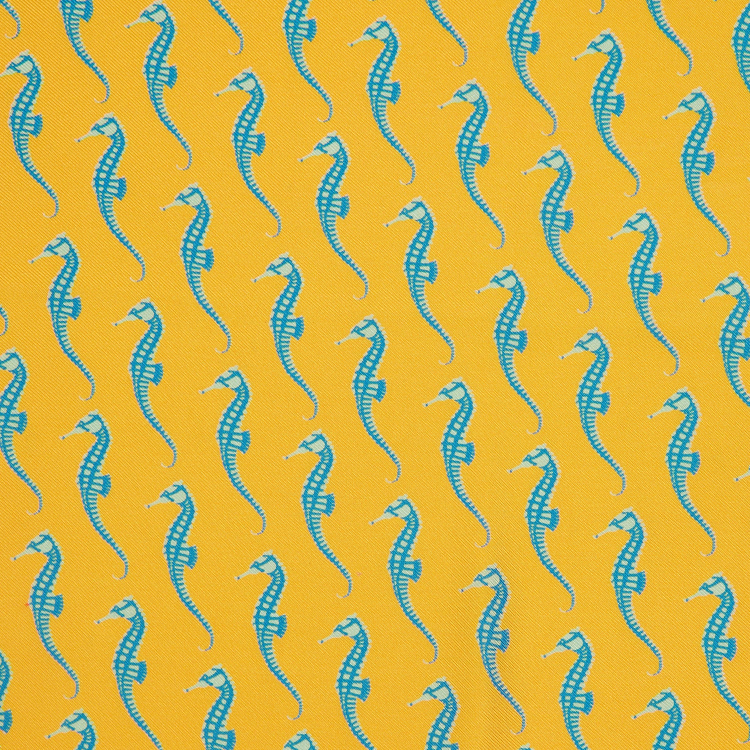 View 2 of product The Turnbull & Asser Yellow & Blue Seahorse Silk Pocket Square features a repeating seahorse pattern in diagonal rows and is handprinted in England, with branding in two corners.