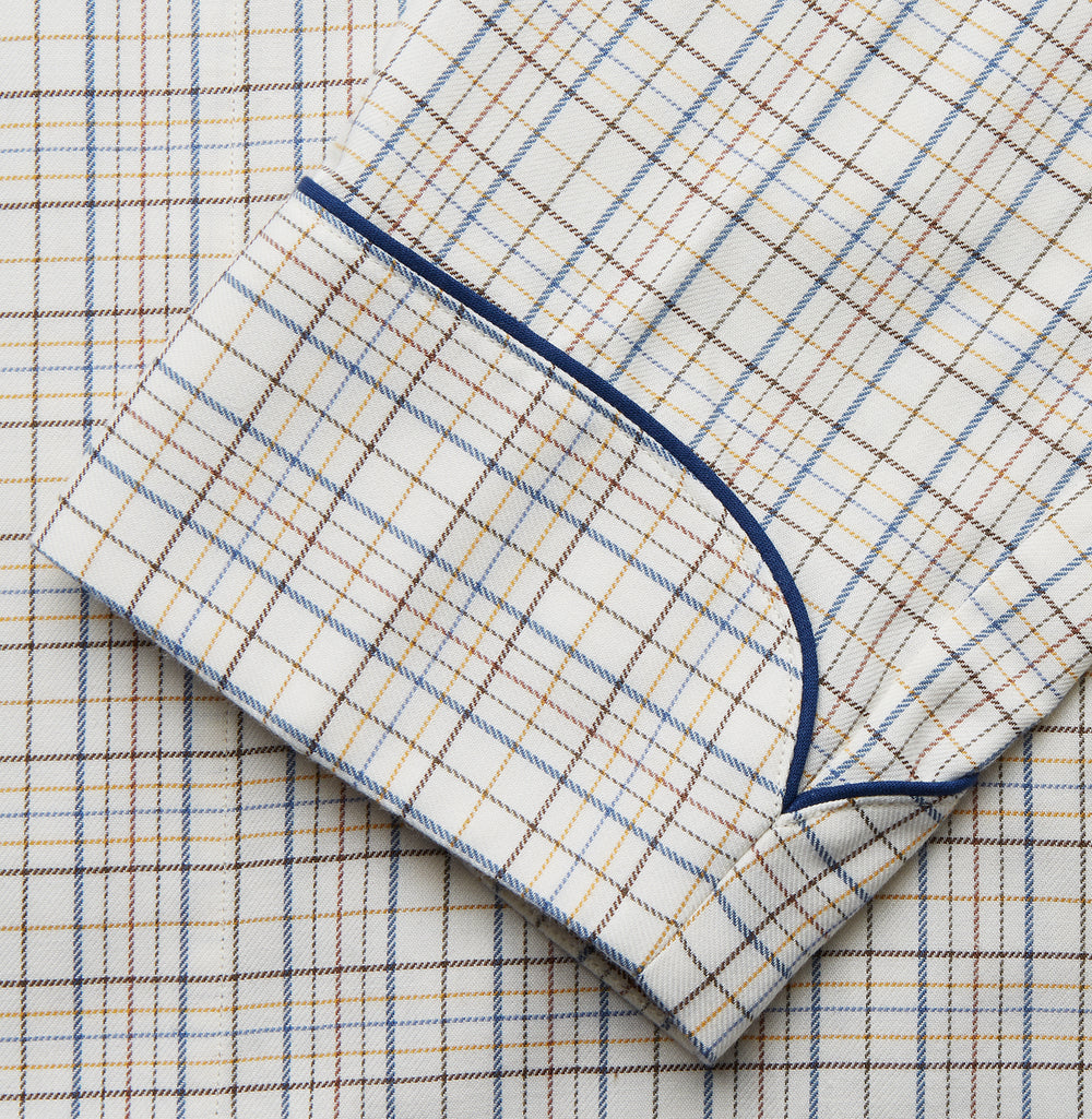 The Turnbull & Asser Brown Multi Check Cotton-Cashmere Gown features a shawl collar, front pocket, matching belt, and dark piping on the edges, sleeves, and pocket. Made in England and shown on a plain white background.