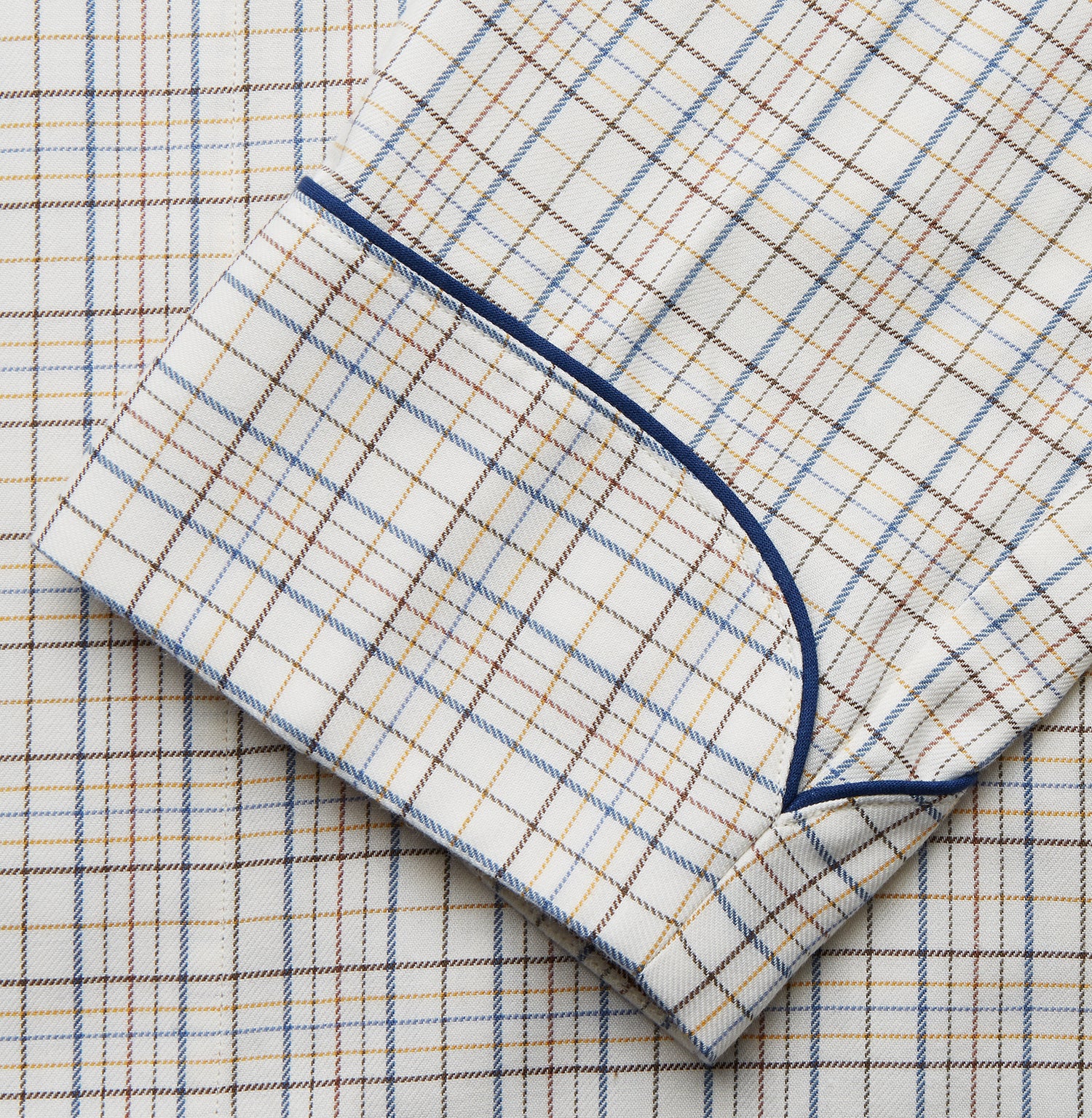 View 3 of product The Turnbull & Asser Brown Multi Check Cotton-Cashmere Gown features a shawl collar, front pocket, matching belt, and dark piping on the edges, sleeves, and pocket. Made in England and shown on a plain white background.