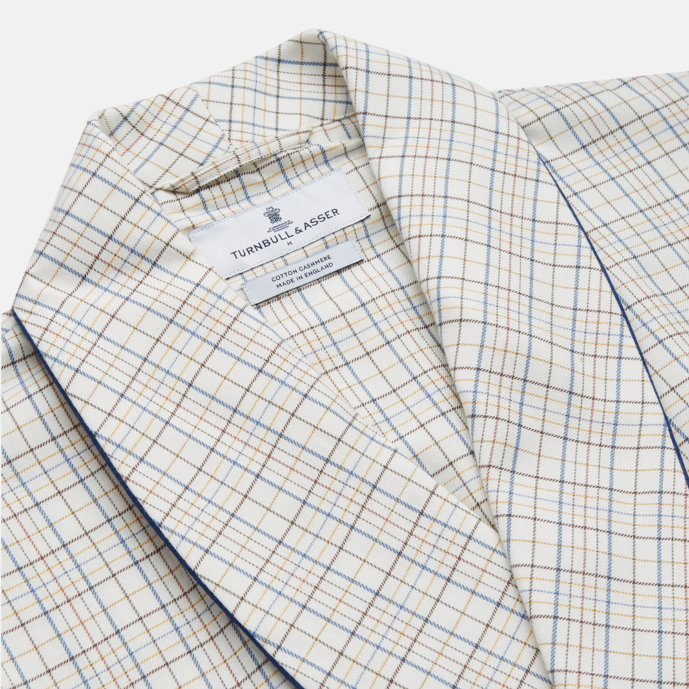 The Turnbull & Asser Brown Multi Check Cotton-Cashmere Gown features a shawl collar, front pocket, matching belt, and dark piping on the edges, sleeves, and pocket. Made in England and shown on a plain white background.