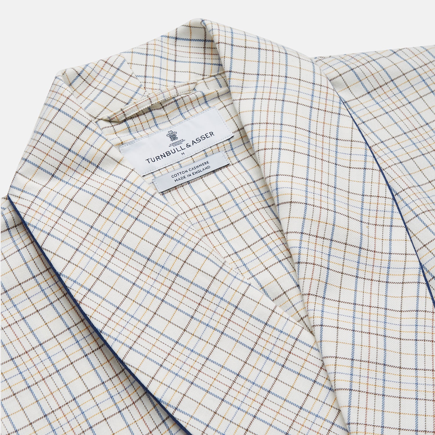 View 2 of product The Turnbull & Asser Brown Multi Check Cotton-Cashmere Gown features a shawl collar, front pocket, matching belt, and dark piping on the edges, sleeves, and pocket. Made in England and shown on a plain white background.